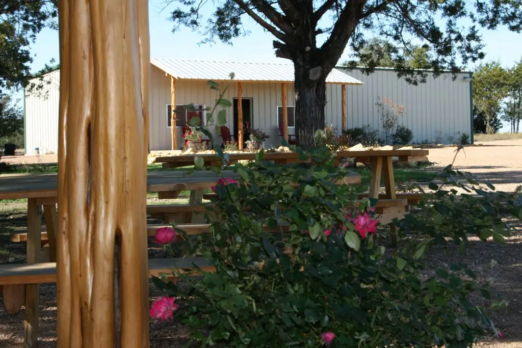 Rec Center exterior at Iron Horse Country Ranch Motocross Summer Camp with flowers and cedar posts