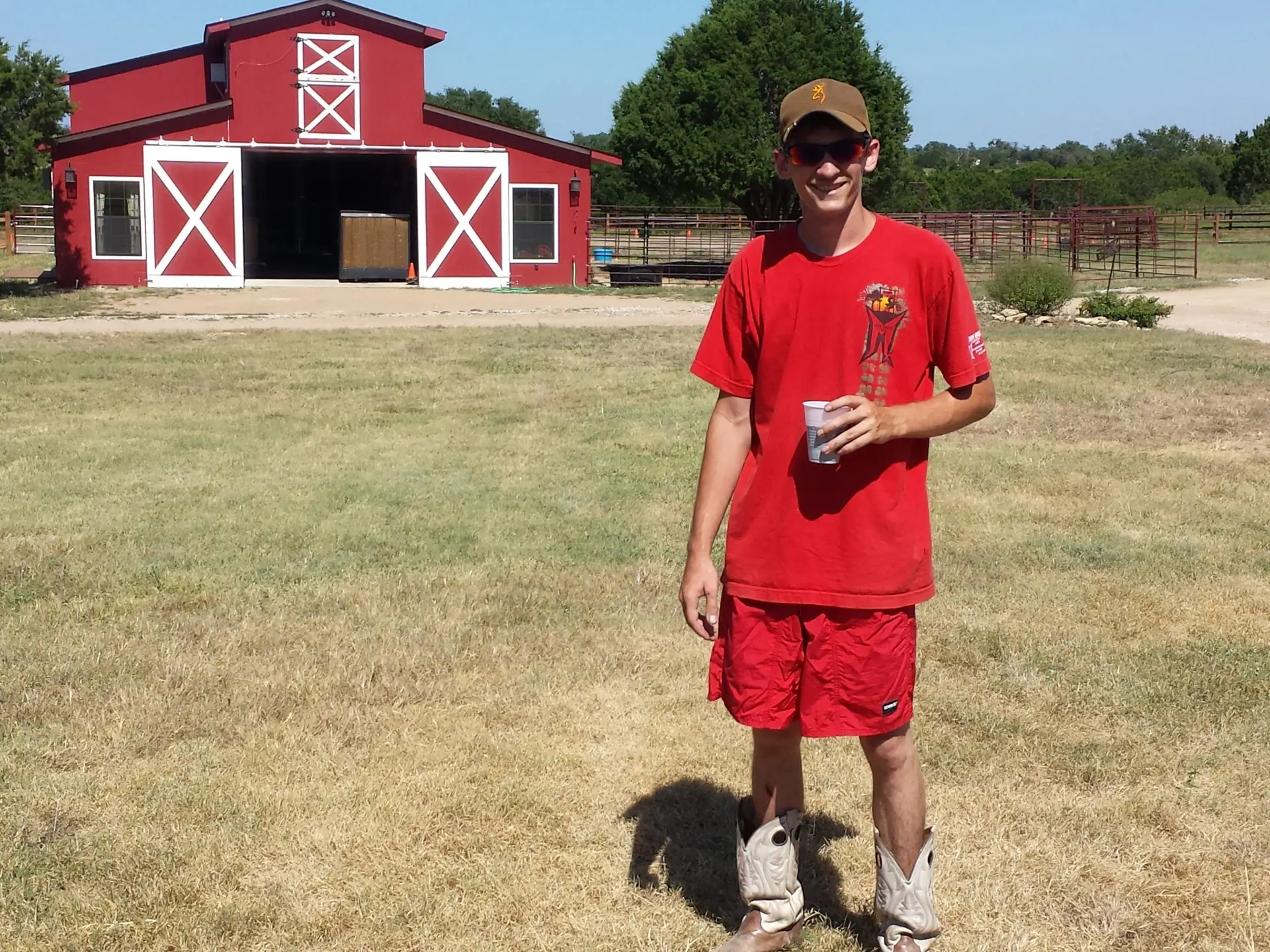 Summer Camp Coach Counselor at Iron Horse Country in motocross training ground arena in front of red barn