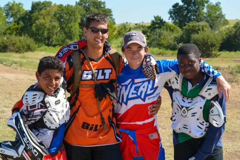 Summer Camp dirt bike Coach with three happy campers at Iron Horse Country motocross ranch