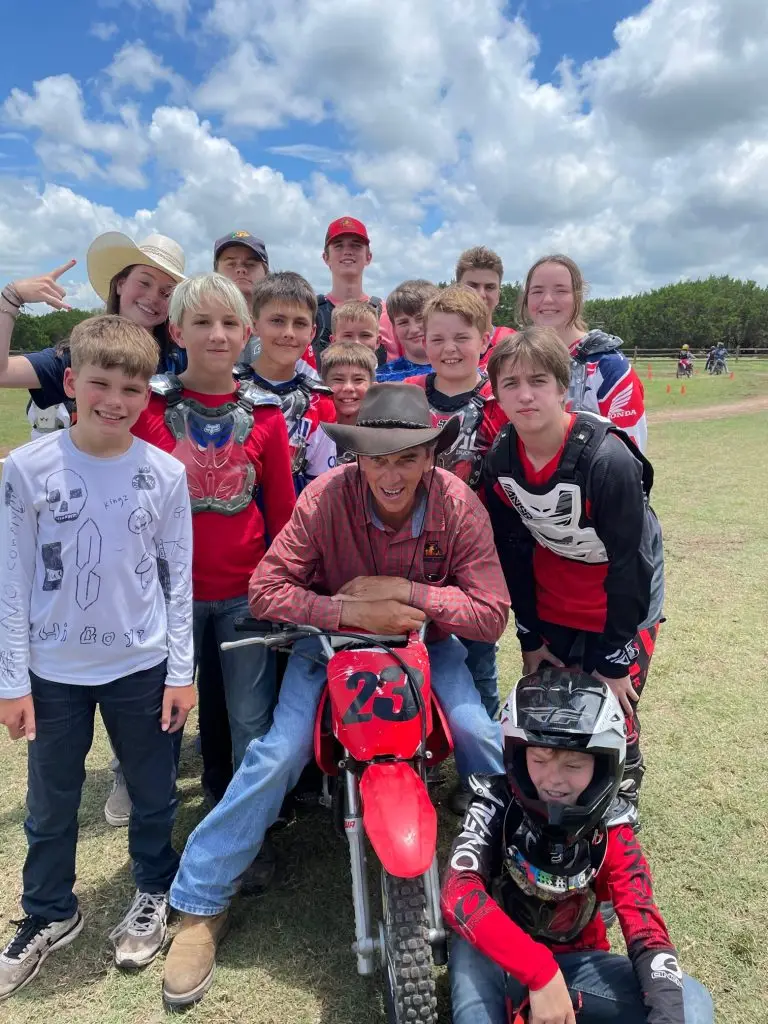 Summer Camp Director Mr. Turner with campers at the Barn Arena practice track at Iron Horse Country Motocross ranch