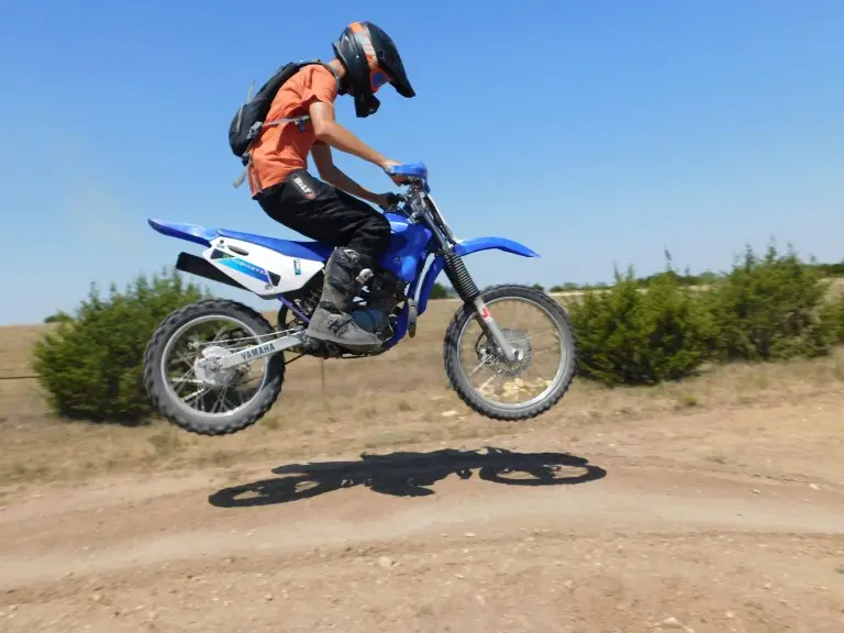 Seth Shirley on blue Yamaha dirt bike at summer camp at Iron Horse Country motocross ranch
