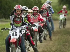 Summer camp riders outdoor activities at Iron Horse Country motocross summer camp Austin Texas in Burnet County